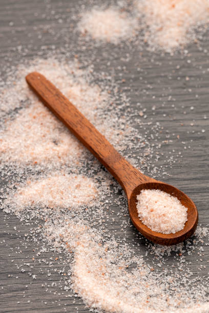 istock Himalayan pink fine salt - Salt in pure crystals on the spoon. 2201989238