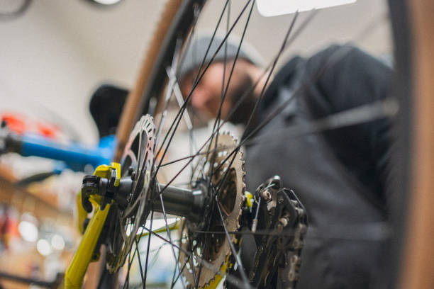 istock Bicycle Repair Shop. Man Customizing Racing Bike 2201989973