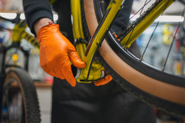 istock Bicycle Repair Shop. Man Customizing Racing Bike 2201989988