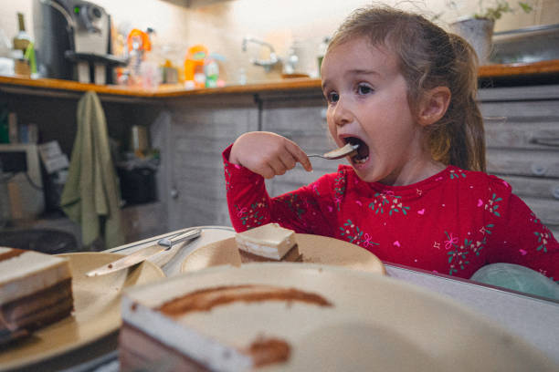 istock Happy Girl Eating Her Fourth Birthday Cake 2201990107