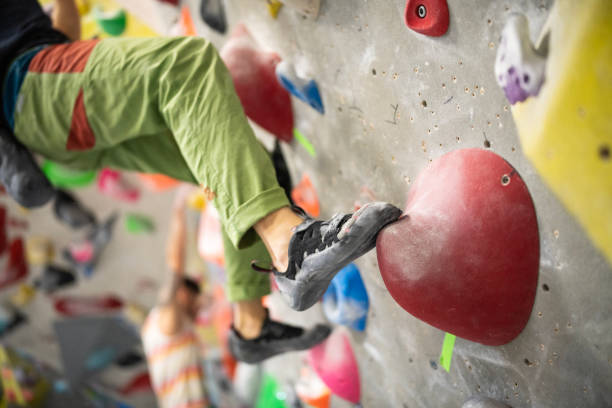 istock Climber gripping the artificial bouldering wall at an indoor climbing gym. 2201990188