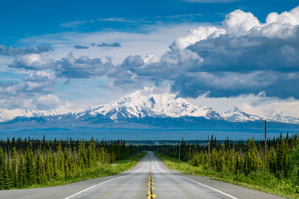 istock Car driving an empty road in Alaska 2201990896