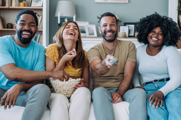 istock Cheerful friends watching TV at home. 2201993858