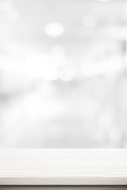 istock Table and blur background, Vertical white wooden counter over blur bokeh light background, table top, shelf for food and retail shop, store product display backdrop, banner, mockup, template 2201996182