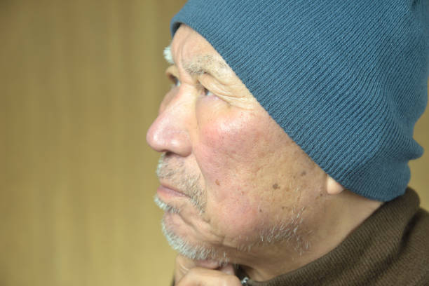 Close-up of an elderly man's troubled face