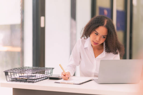 istock Successful businesswoman using laptop to work in office Internet technology company concept: Millennial female professional employee typing email on laptop at work. 2201997649
