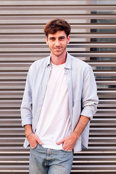 istock man smiling looking at camera with hand in pocket 2202002051