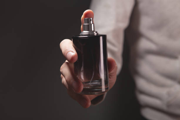 istock hand with bottle of perfume 2202002463