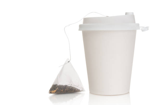 istock Disposable paper cup with tea bag isolated on white background 2202002906
