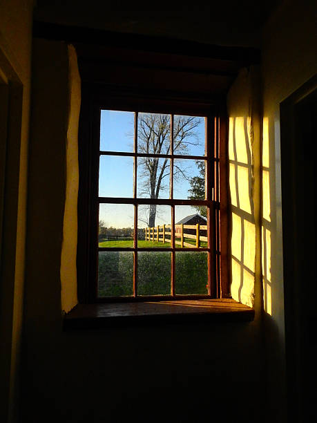 Picturesque view through an old window in the late afternoon in a rural area