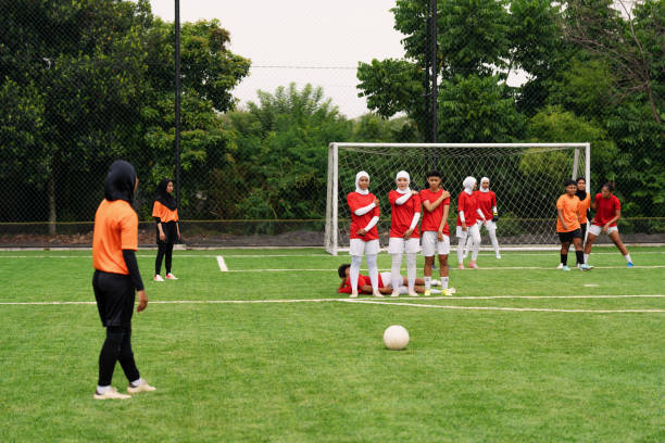 Group of male socer players outdoors on soccer field.