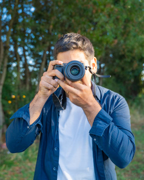 istock Capturing Beautiful Moments A Dedicated Photographer with Camera in Outdoor Settings 2202006609