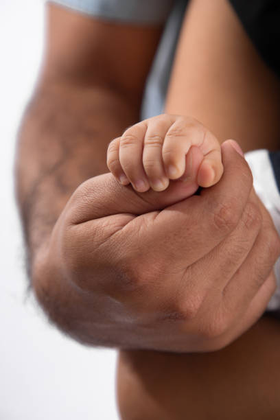 istock Tiny newborn baby human hands and fingers 2202010715