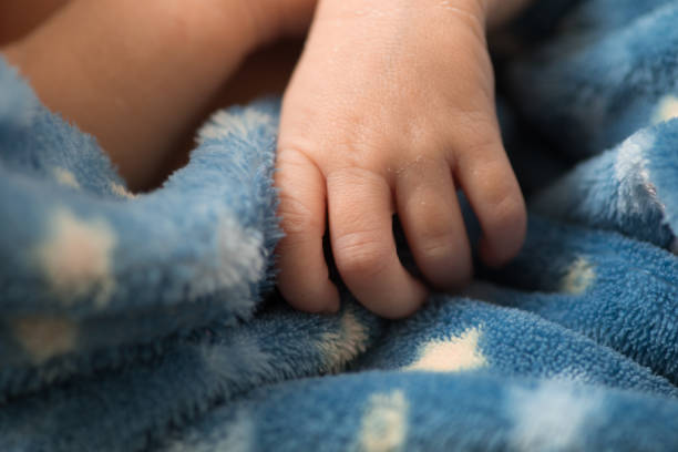 Close up baby's feet portrait Closeup newborn baby feet sleeping on bed near window at bedroom Baby girl sleeping until early morning
