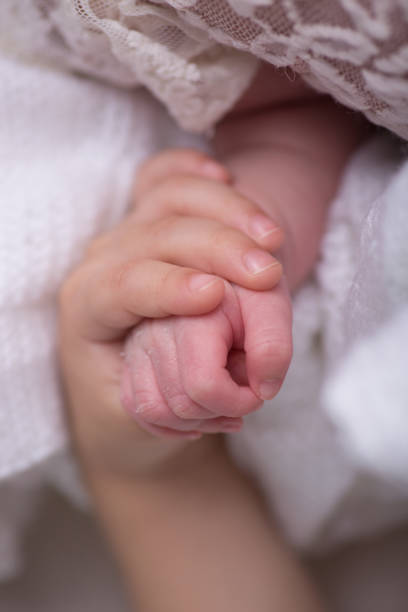 istock Tiny newborn baby human hands and fingers 2202010867