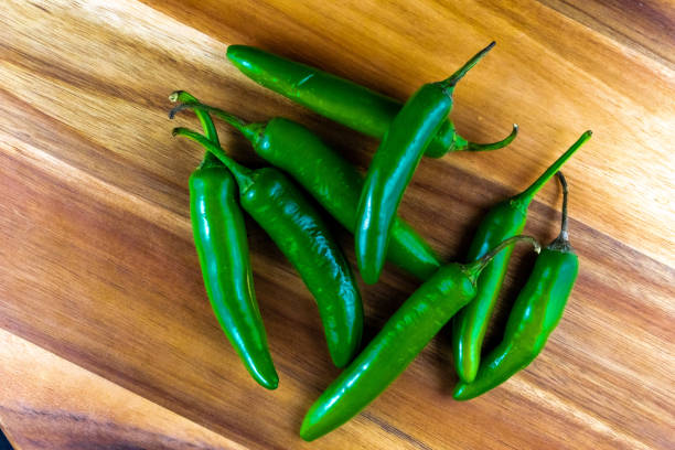 istock Green Chili peppers on a wooden table 2202011497