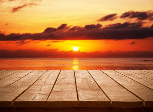 istock Empty wooden table top with tropical ocean sunset background 2202014182