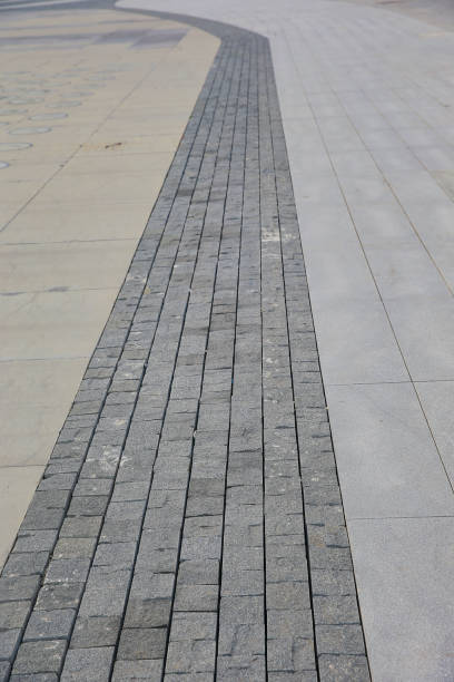 istock rough wet street pathway in grid pattern for design, top view. cobble granite stone, 2202014282