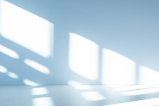istock Studio style background wall decoration presentation uses white and blue tones. with shadows cast from a nearby window, concept creating a decorative 2202014561