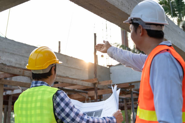 istock inspector engineer and owner project is inspecting construction and quality assurance new house. Engineers or architects or contactor work to build the house before handing it over to the homeowner 2202015246