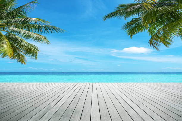 istock Empty wooden terrace on tropical beach by beautiful turquoise sea 2202015266