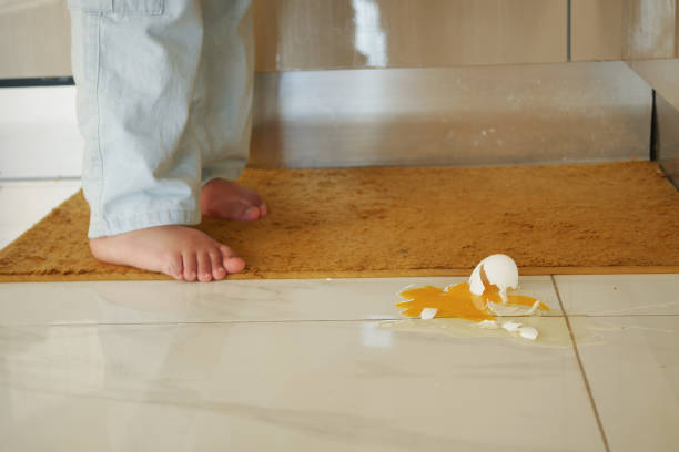 istock A childs tiny footsteps are seen next to a broken egg lying on the kitchen floor 2202015393