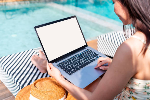 istock Young woman freelancer traveler working online using laptop while traveling for summer vacation, Workation and digital nomad concept 2202015480