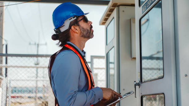 istock Maintenance engineer inspect the electrical control board MDB of solar farm. 2202015886