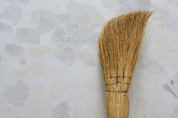 istock Broom on the white wall background with copy space for text. 2202018747