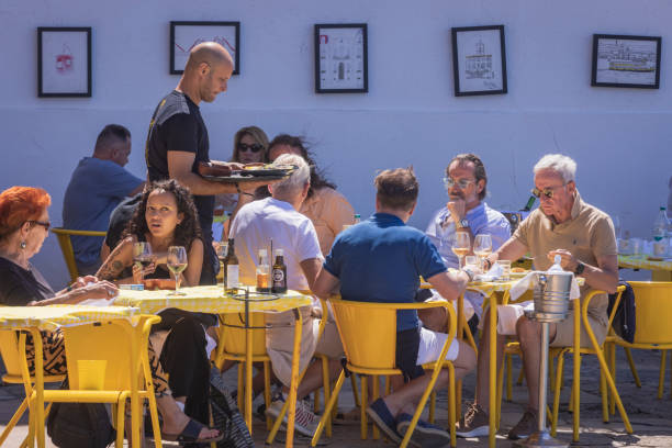 Lisbon, Portugal - June 12, 2024: people on a terrace along the Tagus river
