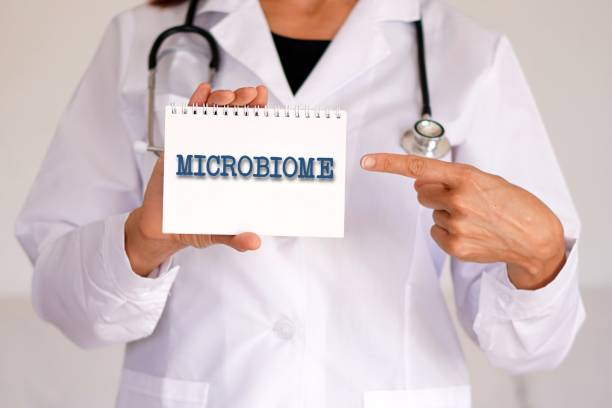 istock microbiome concept. word written in a woman doctor's medical notebook 2202027278