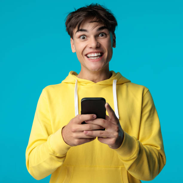 istock joyful casual man reading an email looking like winner 2202027647