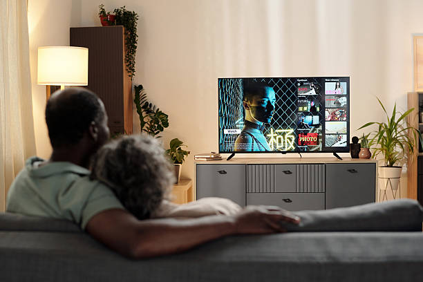 istock Watching Television in Modern Living Room Together 2202029154