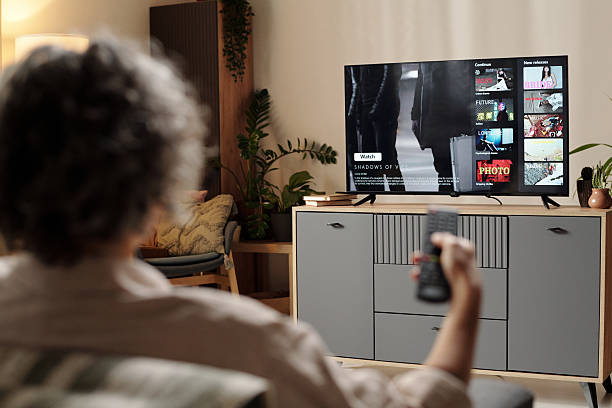 istock Watching Television and Holding Remote Control at Home 2202029515