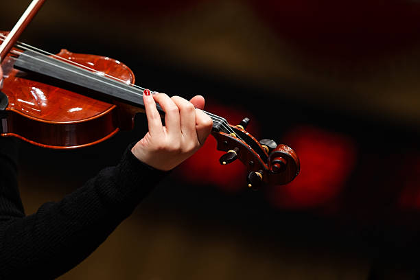 istock Hands of a woman playing the violin 2202029759