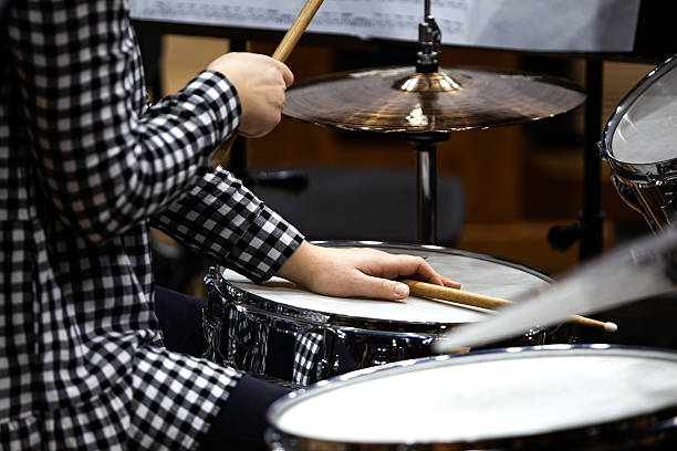 istock Hands of a girl playing a drum set 2202029835