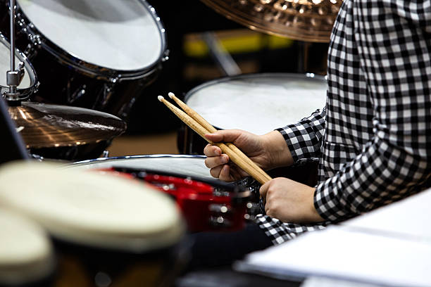 istock Hands of a girl playing a drum set 2202029858