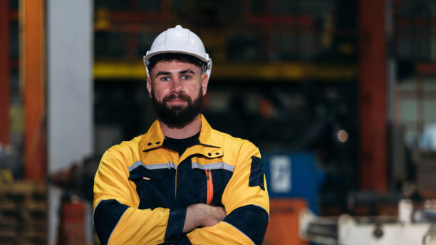 istock Engineers are inspecting a large engine in a factory, while workers focus on maintaining efficiency. 2202030763