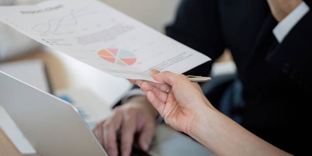 istock Team member presenting financial reports and graphs during a business meeting. 2202030856