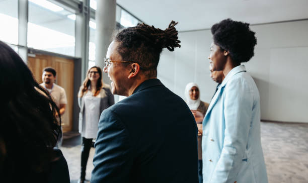 istock Diverse group of professionals networking at a modern business event 2202031103