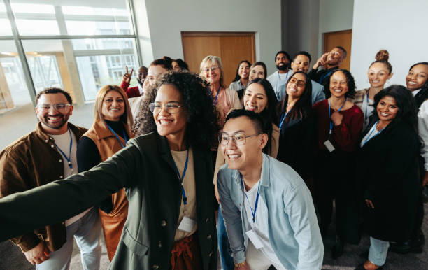 istock Diverse group of professionals taking a selfie at a successful conference, showcasing teamwork and unity during a training session 2202031162