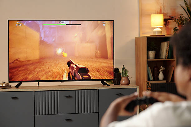 istock Engaging in Video Game on Large Monitor 2202031603