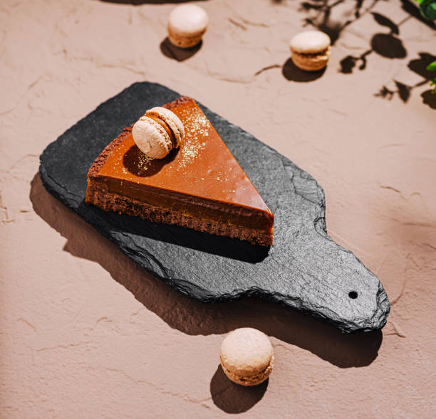 istock Delicious chocolate cake with macarons presented on a rustic surface in a cozy outdoor setting 2202034498