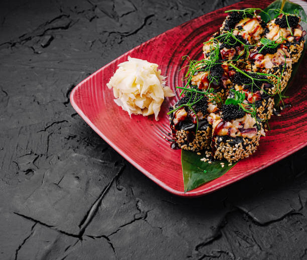istock Sliced sushi roll with fresh ingredients served on a decorative plate during a culinary meal 2202034918
