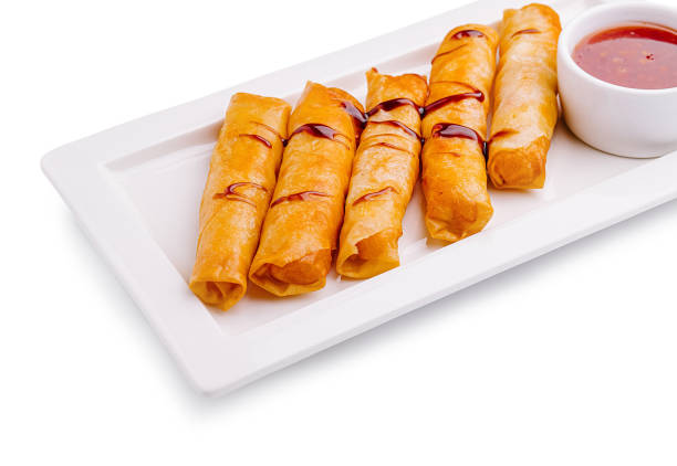 istock Delightful crispy spring rolls served with sweet and tangy dipping sauce on a white platter 2202035285