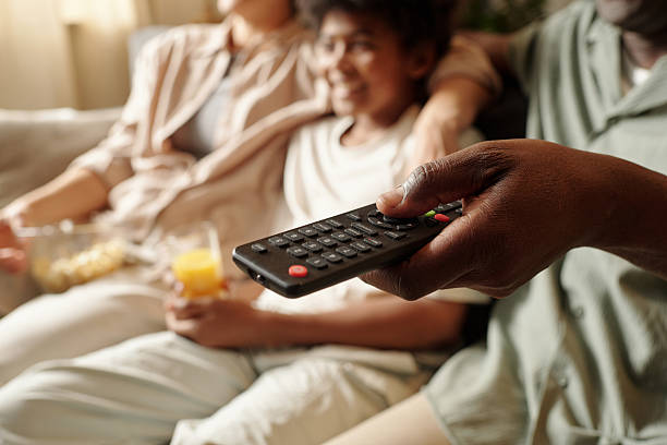 istock Enjoying Family Time Watching Television Together 2202036150