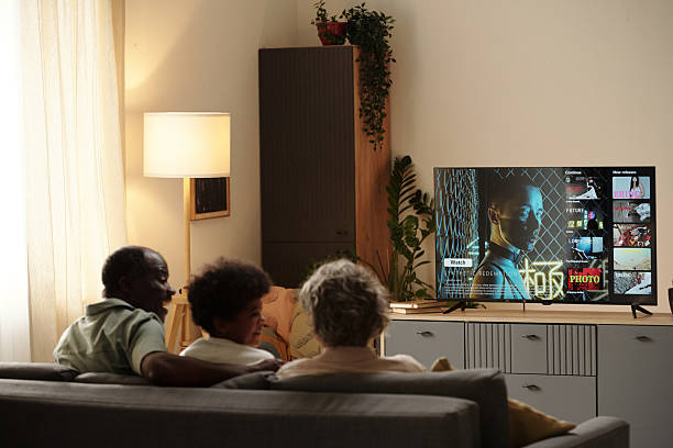 istock Watching TV Together in Cozy Living Room Environment 2202036667