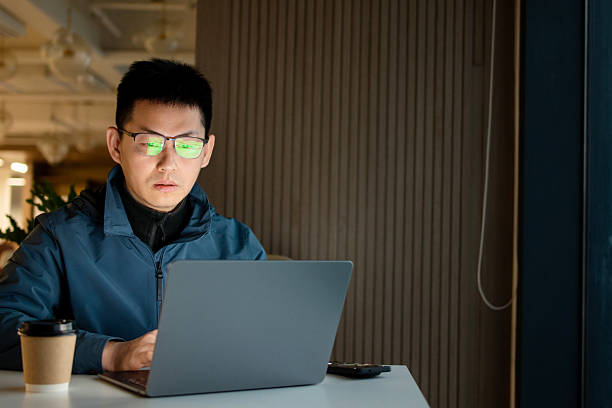 istock asian businessman working on laptop in office 2202040567