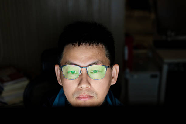 istock asian businessman is working on computer overtime late at night 2202040759