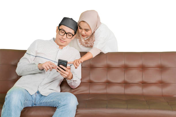 istock Muslim Couple Engaging with Smartphone on a Sofa 2202041067